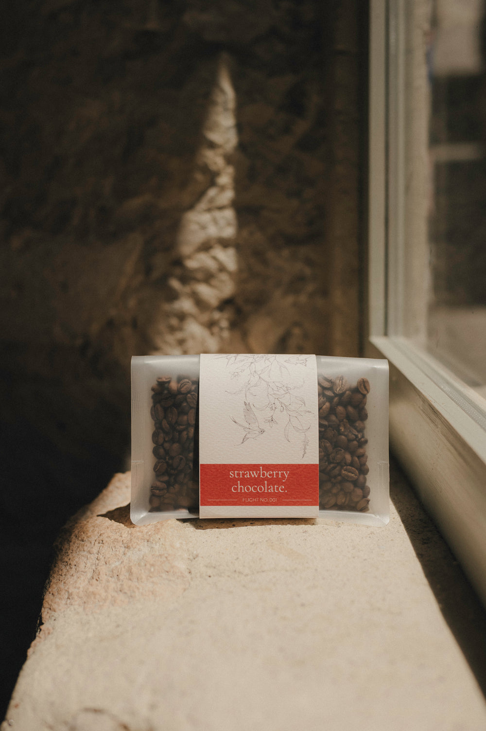 Swallow Strawberry Chocolate specialty coffee bag on stone windowsill, Alicante